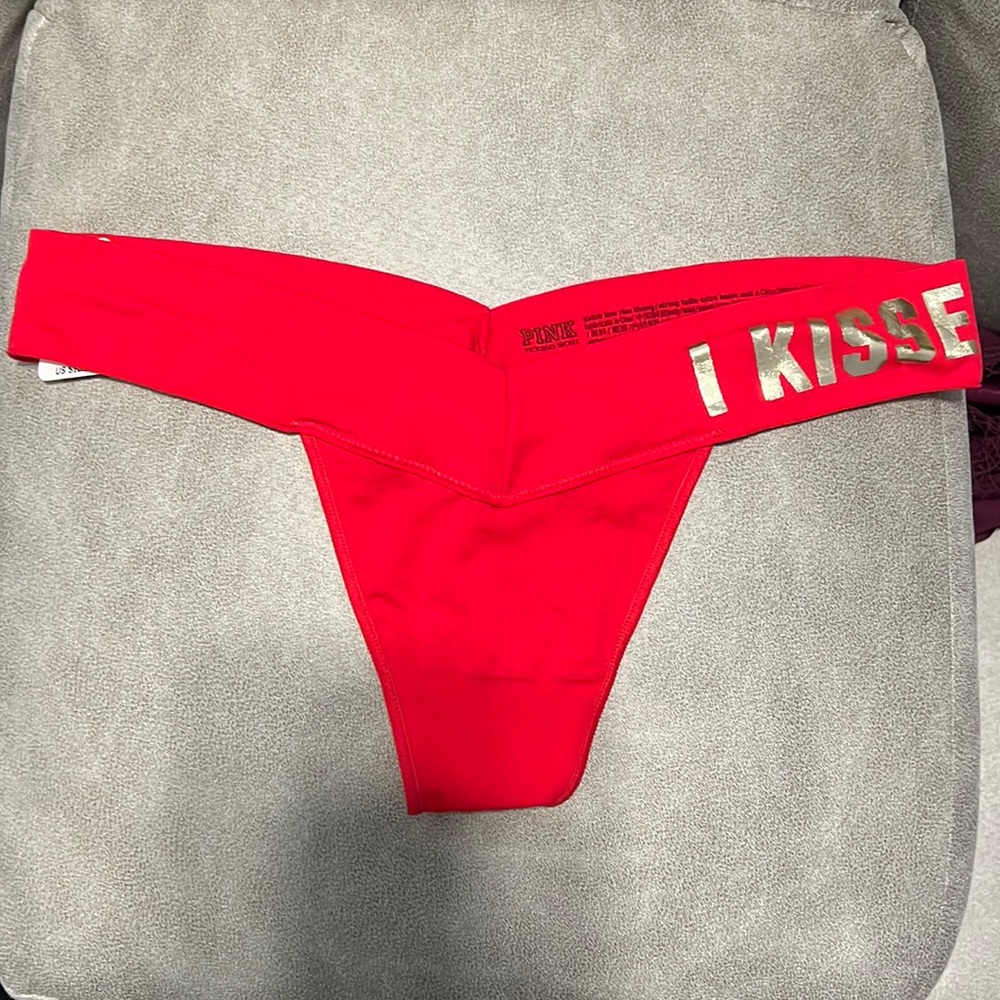 Brand New Thong pink Victoria’s Secret red color, size M, never been worn